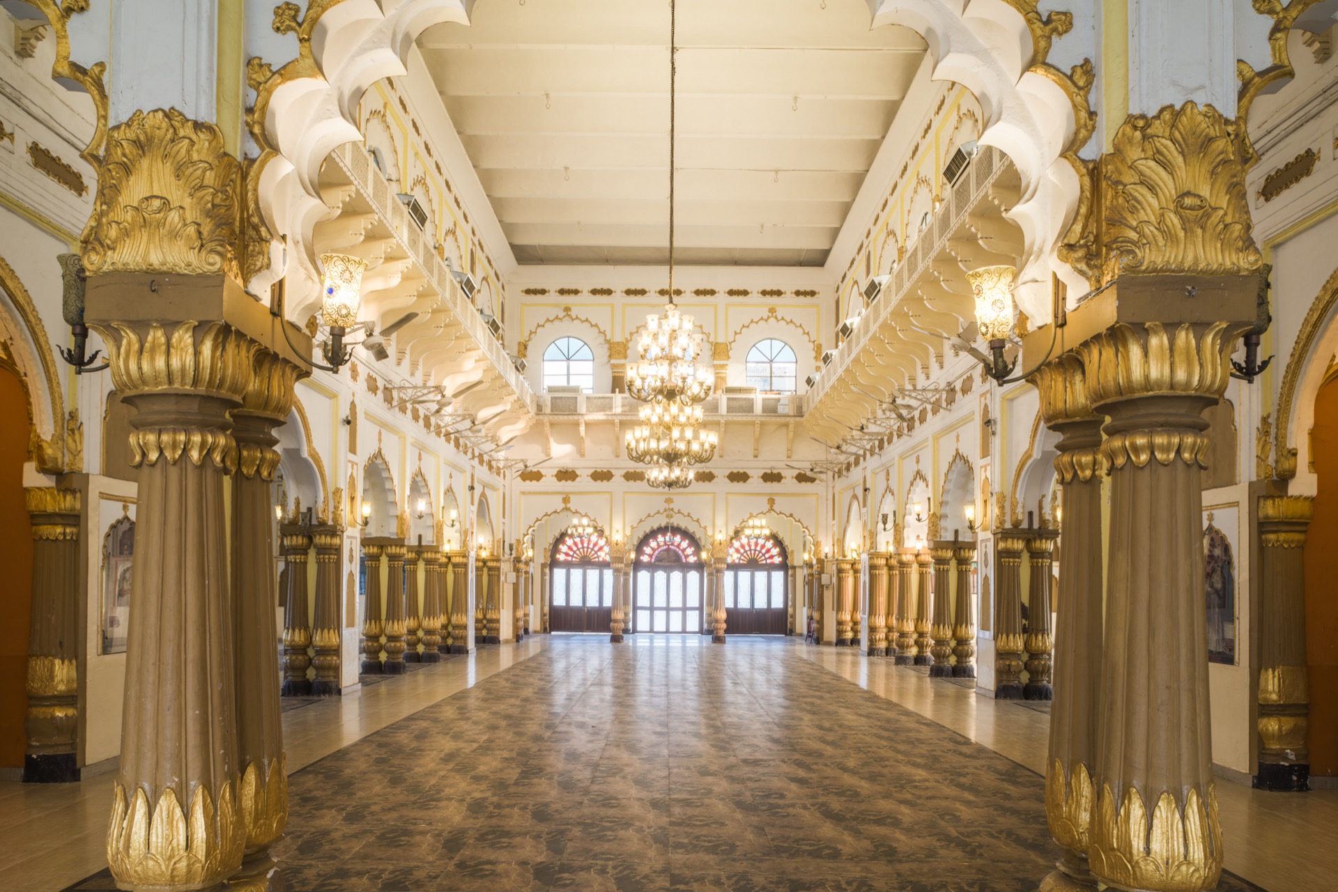 Warm golden pillars and chandeliers in the grand hall