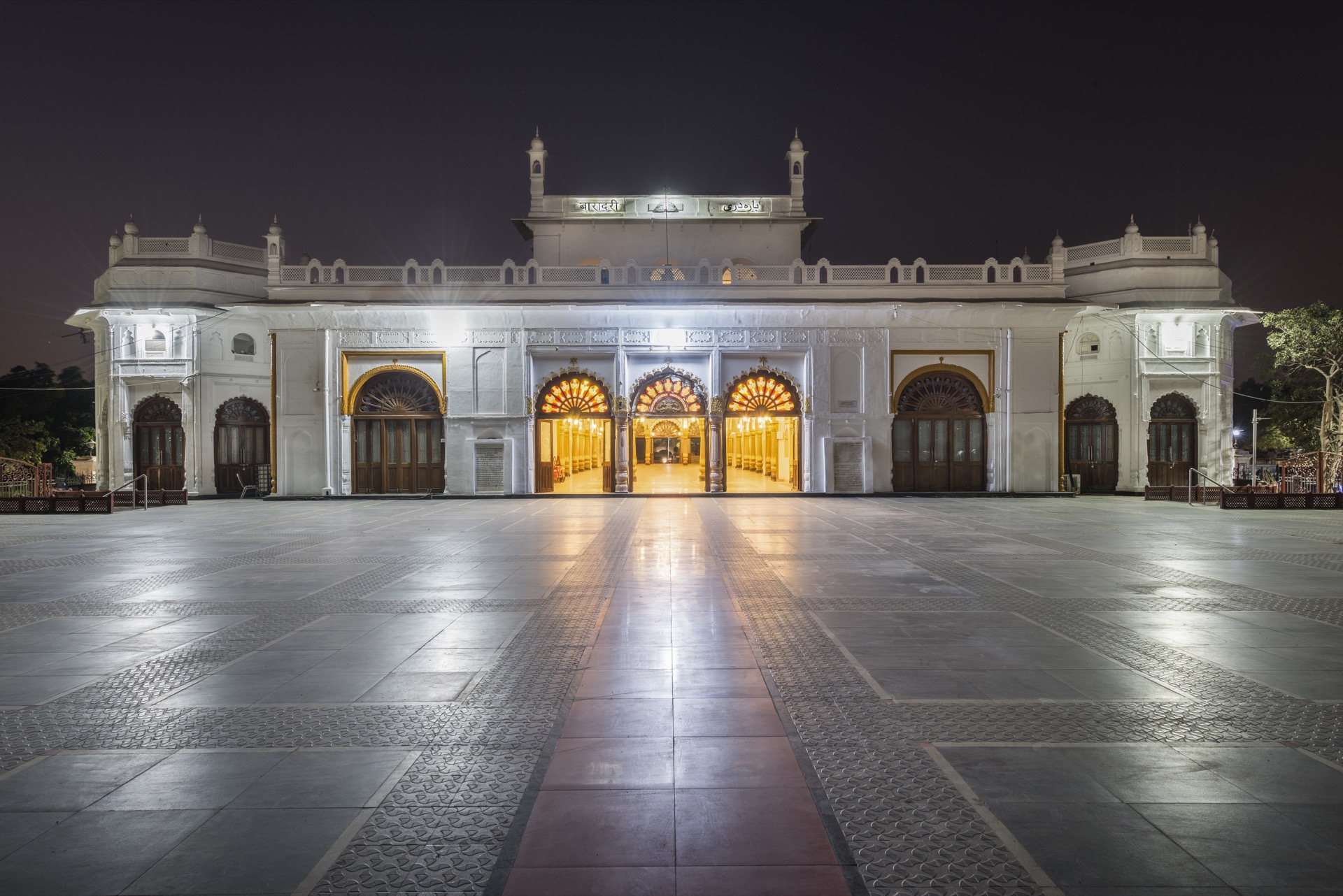 Safed Baradari illuminated at night with golden doorways